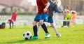 Youth Football Tournament. Youth Players Kicking Soccer Match on grass Stadium Royalty Free Stock Photo
