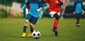 Youth Football Tournament. Youth Players Kicking Soccer Match on grass Stadium Royalty Free Stock Photo