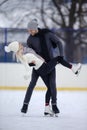 Youth Fun Time Ideas. Relaxing Caucasian Couple Skating Together While Standing Embraced On Ice At Skating Rink Outdoors