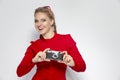 Youth Ideas and Concepts. Cute and Positive Caucasian Blond Girl With Old School Film Camera in Red Dress with Sunglasses. Against Royalty Free Stock Photo