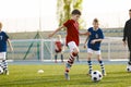 Youth Junior Athletes in Red and Blue Soccer Shirts. Two Boys Compete for the Ball Royalty Free Stock Photo