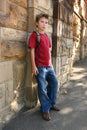 Youth leaning against wall