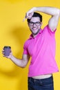 Youth lifestyle. Smiling Handsome Young Man With Sincere Beautiful Toothy Smile Posing With Coffee Cup on Yellow Background While