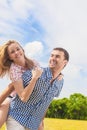 Youth Lifestyle, Summer Vacations, Dating, Love, Happiness Concepts. Happy caucasian Couple Piggybacking Outdoors. Against Nature Royalty Free Stock Photo