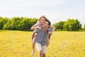 Youth Lifestyle, Summer Vacations, Dating, Love, Happiness Concepts. Happy caucasian Couple Piggybacking Outdoors. Against Nature Royalty Free Stock Photo