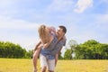 Youth Lifestyle, Summer Vacations, Dating, Love, Happiness Concepts. Happy caucasian Couple Piggybacking Outdoors. Against Nature Royalty Free Stock Photo