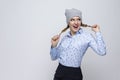 Youth Lifestyles. Portrait of Happy Caucasian Blond Girl in Warm Winter Hat and Blue Shirt Posing With Stretched Hair Tails on