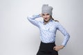 Youth Lifestyles. Portrait of Happy Caucasian Blond Girl in Warm Winter Hat and Blue Shirt Posing on White Background