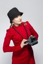 Youth Lifestyles. Posiitve Caucasian Blond Girl Posing With Old School instant Camera in Red Dress