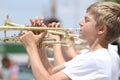 Youth plays trumpet in parade in small town America