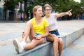 Youth positive girls sitting in city park together Royalty Free Stock Photo