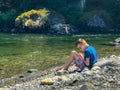 Youth in quiet thought by river bank