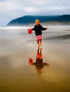 Child Running on Beach at Low Tide