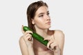 Youth secrets. Close up of beautiful young woman with cucumber over white background. Cosmetics and makeup, natural and Royalty Free Stock Photo