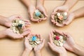 Youth show hand holding a model home and coin and the wooden background, Saving money for buy a new house and loan for plan Royalty Free Stock Photo