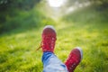 Youth sneakers on girl legs on grass