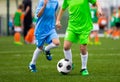 Youth Soccer Players. Boys Kicking Football Ball on the Field Royalty Free Stock Photo