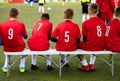 Youth Sport Soccer Team Sitting on Bench. Young Footballers Royalty Free Stock Photo