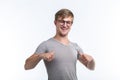 Youth, student and people concept - young man looks like a nerd show us thumbs up over the white background Royalty Free Stock Photo