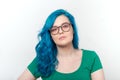 Youth, stylish and fashion concept - Young beautiful woman with blue hair and eyeglasses is smiling over white Royalty Free Stock Photo