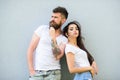 Youth stylish outfit. Couple white shirts cuddle each other. Couple friends hang out together grey wall background. Feel