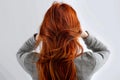 Youthful beauty Red haired womans back view, white background, copy