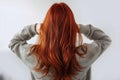 Youthful beauty Red haired womans back view, white background, copy