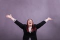 Youthful business woman in black suit arms wide open and raised in the air Royalty Free Stock Photo