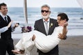 Youthful mature couple getting married at the beach Royalty Free Stock Photo