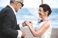 Youthful mature couple getting married at the beach Royalty Free Stock Photo
