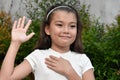 Youthful Philippina Child Pledging Allegiance Outdoors