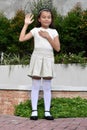 Youthful Philippina Child Pledging Allegiance Standing In Park