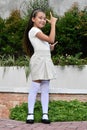 Youthful Philippina Female Child Pointing Wearing Skirt Standing In Park