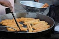 Youtiao, also known as many names Chinese cruller, Chinese fried churros, Chinese oil stick frying in the pan Royalty Free Stock Photo