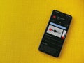 YouTube Kids app play store page on smartphone on a yellow fabric background