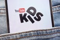 YouTube Kids logo displayed on smartphone hidden in jeans pocket