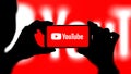 Youtube logo on smartphone with red background. New York, USA - November 30, 2023.