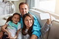 When youve got family, youve got it all. a happy young family taking selfies together on the sofa at home. Royalty Free Stock Photo