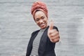 Youve got my backing. Cropped portrait of an attractive young businesswoman giving you thumbs up against a grey brick Royalty Free Stock Photo