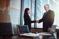 Youve got yourself a deal. two businesspeople shaking hands after coming to an agreement.