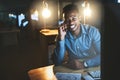 Youve gotta do what youve gotta do. a handsome young businessman making a phonecall while working late at night in a Royalty Free Stock Photo