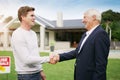 Youve made the right purchase. Shot of a young man meeting with an estate agent at his newly purchased home. Royalty Free Stock Photo