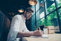 Yow angle view of a young stylish well dressed author writer is Royalty Free Stock Photo