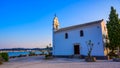 Ypapanti Church - Beautiful scenery at sunset in Gouvia Bay Ã¢â¬â small ancient white church on a pier, Corfu island, Ionian sea, Royalty Free Stock Photo