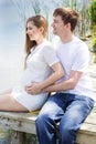 Ypung couple are sitting on bridge Royalty Free Stock Photo