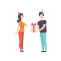 Ypung man giving gift box decorated with red ribbon bow to girl in party hat, people celebrating holidays concept