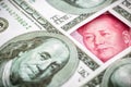 Yuan banknote, surrounded by 100 dollar bills. American market protectionism concept