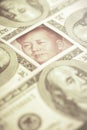 Yuan banknote, surrounded by 100 dollar bills. American market protectionism concept