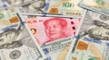 100 yuan banknote among 100 US dollar banknotes