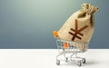 Yuan Yen money bag in a shopping cart. Profits and super profits. Minimum living wage. Business and trade concept Royalty Free Stock Photo